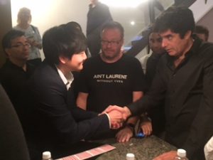 Ed Kwon shaking David Copperfield's hand